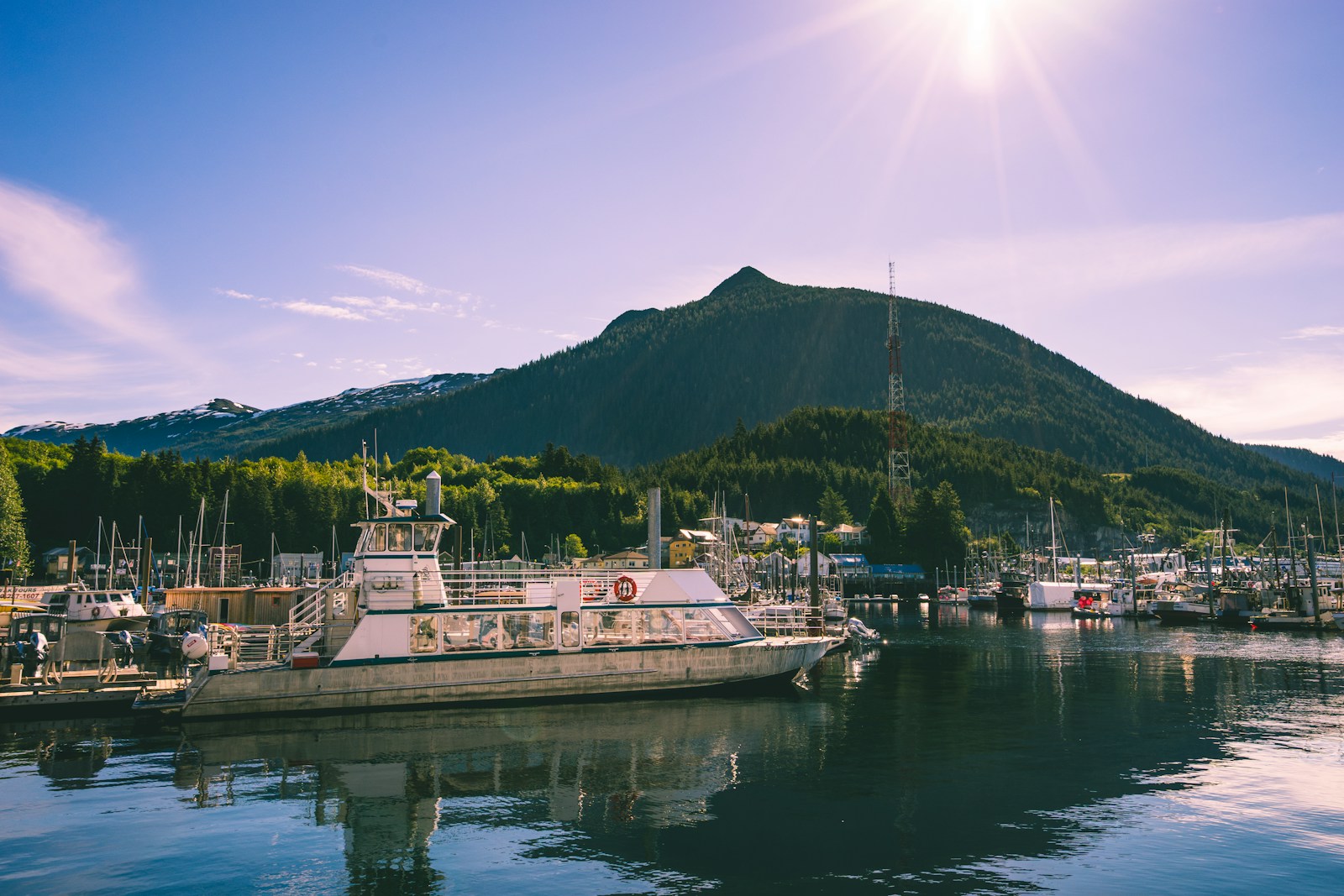Fishing boats in Ketchikan harbor below green mountains